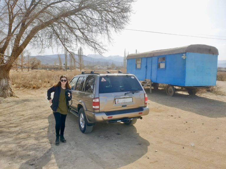 Standing in front of car in Kyrgyzstan